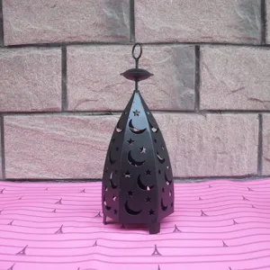 Detailed view of the vintage black iron star and moon hollow candle holder for home decor.