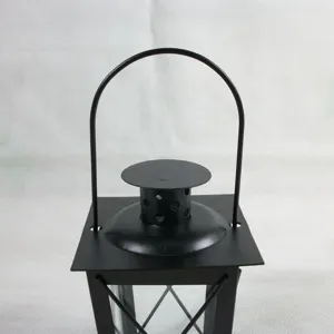 Black iron candle lantern detail shot, Moroccan style wind lamp top handle close up view