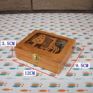 Wooden music box with cute giraffe pattern cutout and hand crank, natural wood gift and decor.