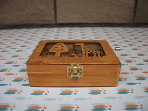 Wooden music box with clear lid, featuring cute giraffe and forest trees design for gift.