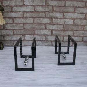 Detail view of two black acrylic frame Newton's cradle balance balls, ideal office decor.
