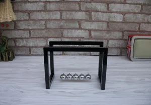 Detail shot of the black acrylic Newton cradle balance balls, perfect desk toy and office decoration.