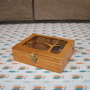 Detail shot of wooden music box with owl cutout design and metal clasp for home decor.
