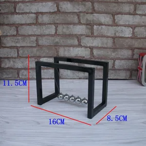 Detailed view of the Newton cradle balance balls showing physical motion and precise dimensions.