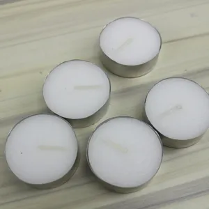 Detail shot of white round tea light candles with aluminum holders for home decor and party