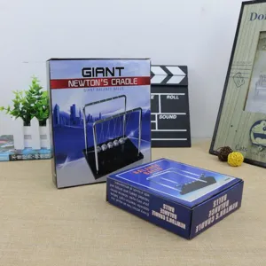 Detail shot of Giant Newton Cradle balance balls box and physics office desk decoration.