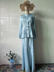 Detailed view of the elegant light blue satin long sleeve top and long skirt set displayed.