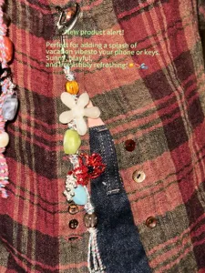 Detailed shot of summer beaded phone charm with floral and colorful elements, perfect style.