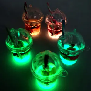 Close-up detail of glowing resin cup charms, luminous mini drink pendants for DIY crafts.