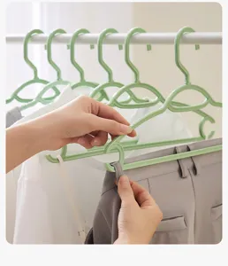Close-up detail view of plastic clothes hangers featuring non-slip design and hanging hooks.
