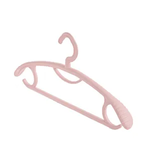 Pink plastic clothes hanger with anti-slip design, durable home storage organizer for dorm use.