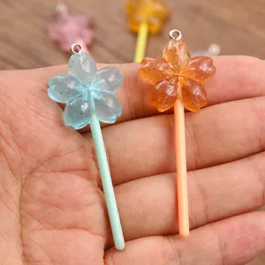 Resin cherry blossom lollipop shaped DIY charm pendant detail view, perfect for crafts.
