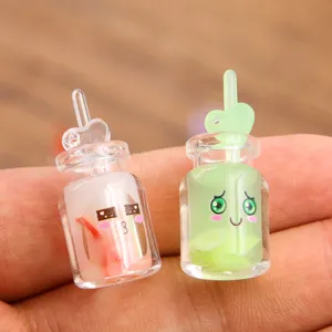 Cute DIY resin bottle charm detail with heart straw and facial expression for crafts.