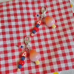 Cute fruit beaded phone chain and bag charm featuring strawberry and ice cream designs for summer.