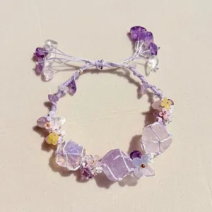 Handmade purple crystal stone woven bracelet detail, cute floral charm pendant jewellery.