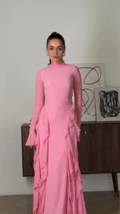 Detail view of the pink high-neck long sleeve dress featuring delicate ruffles and mesh sleeves.