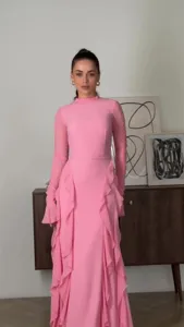 Pink ruffle high-neck long-sleeve dress detail, elegant chiffon style for spring fashion look.