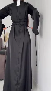 Elegant black long sleeve maxi dress back view showing adjustable waist tie detail.