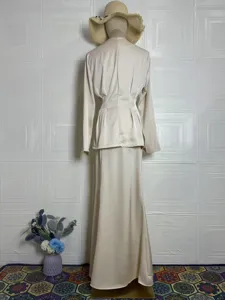 Elegant solid color long sleeve top and long skirt set, retro spring outfit detail view.