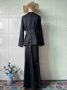 Elegant black long sleeve top and long skirt set, vintage style, comfortable spring outfit detail.