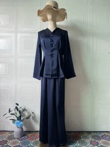 Details of the elegant solid color long sleeve top and long skirt set in navy blue satin.