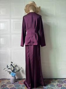 Detailed view of the elegant purple long-sleeve top and maxi skirt set, featuring smooth satin.