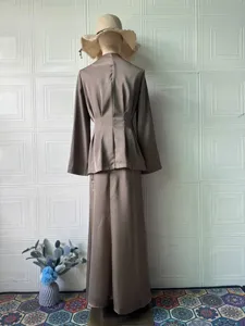 Detailed view of a vintage solid color satin long sleeve top and skirt set shown on mannequin.
