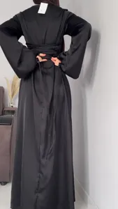 Back detail view of elegant black satin long sleeve maxi dress with stylish waist tie belt.