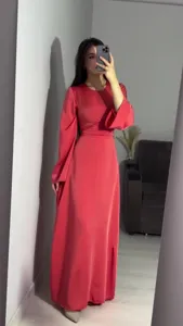 Detail view of the elegant solid color long sleeve maxi dress, featuring a waist-cinching design.