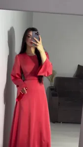 Detailed view of the elegant red long-sleeve waist-cinching maxi dress for women.