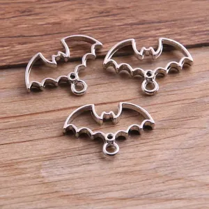 Detailed view of silver bat hollow bezel pendant charms for DIY jewelry making accessories.