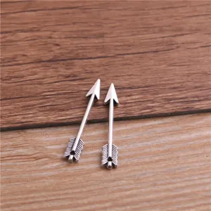 Mini silver arrow charms for DIY jewelry making, detailed metal weapon pendant accessory.