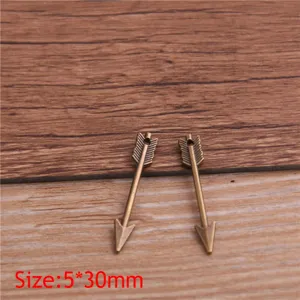Mini alloy arrow pendant detail shot, vintage bronze weapon charm for DIY jewelry making.