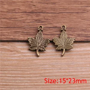 Detailed close-up view of antique bronze leaf charms, perfect for DIY jewelry making crafts.