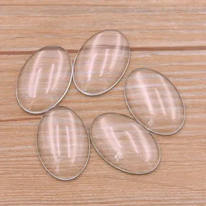 Clear glass oval cabochons in mixed sizes, perfect for DIY jewelry making and crafts.