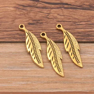 Antique gold leaf feather charms for DIY jewelry making, detailed metal alloy pendant design.