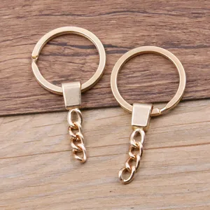 Golden metallic key ring detail shot with short chain, perfect for DIY jewelry crafting.
