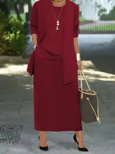 Detailed shot of the elegant wine red women's three-piece skirt set in an outdoor setting.