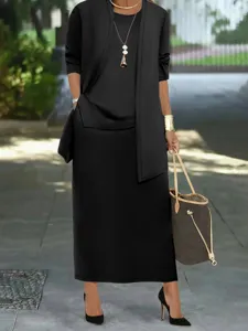 Detail view of the elegant black three-piece skirt set worn in outdoor street scene