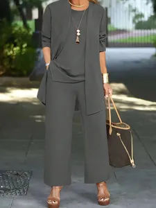 Outdoor detailed view of a stylish grey three-piece pants set featuring a matching cardigan.