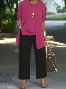 Detailed view of the chic three-piece outfit showcasing the magenta cardigan and black pants.