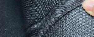Detailed view of the car mat showing anti-slip honeycomb texture and durable woven edge binding.