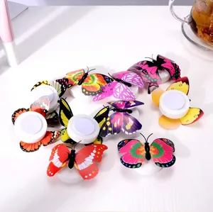 Close-up detail of colorful LED glowing butterfly wall night lights with adhesive base set.