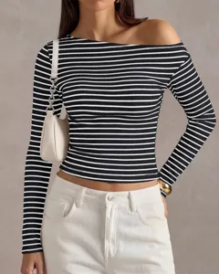 Detail shot of black and white striped off-the-shoulder long sleeve top knit fabric texture.