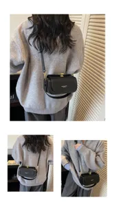 Black leather shoulder bag for women, chic pillow crossbody purse for daily commuting.