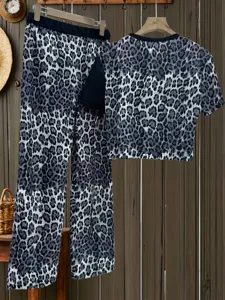 Stylish leopard print two piece pajama set featuring a short sleeve top and straight pants.