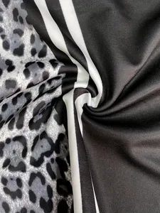 Close-up fabric detail showcasing stylish leopard print and dual-stripe black material.