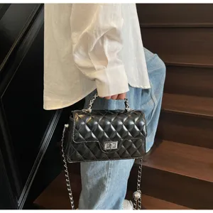 Chic black quilted shoulder bag with chain strap and turn lock for women spring summer style.