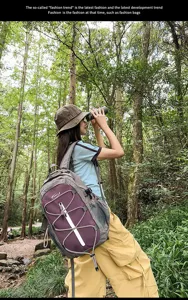 Outdoor backpack detail in forest scene, stylish color block design with utility cords.