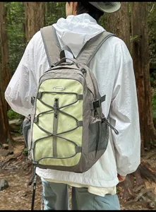Forest style color block backpack detail showcasing elastic bungee cord and convenient side mesh pockets.